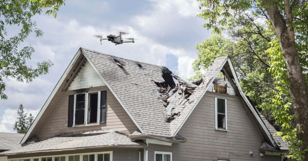 drone-hovering-over-damaged-house